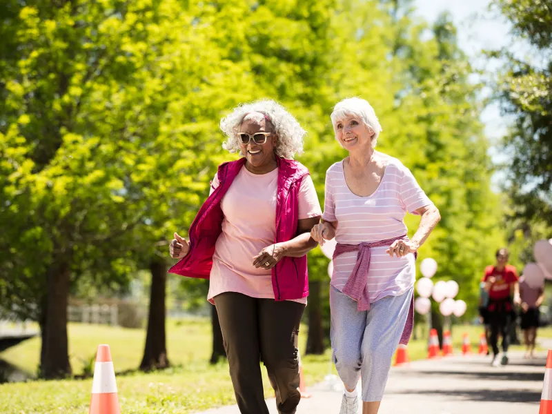 Two elderly women enjoying a walk in the park.